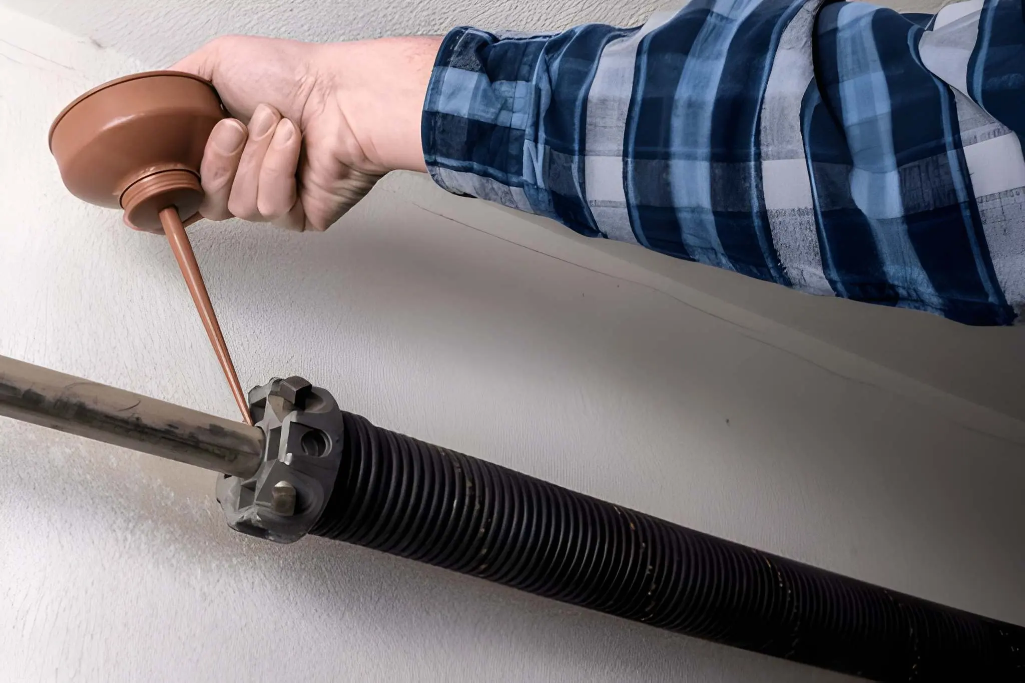 Technician performing expert Garage Door Spring Repair with high-quality tools and safety measures